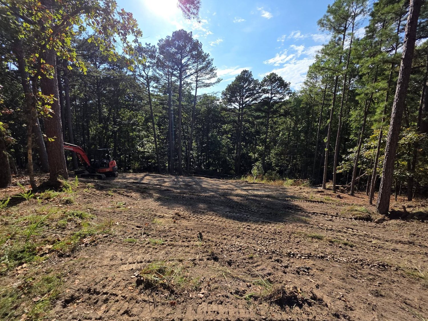 A wooded lot cleared and graded flat