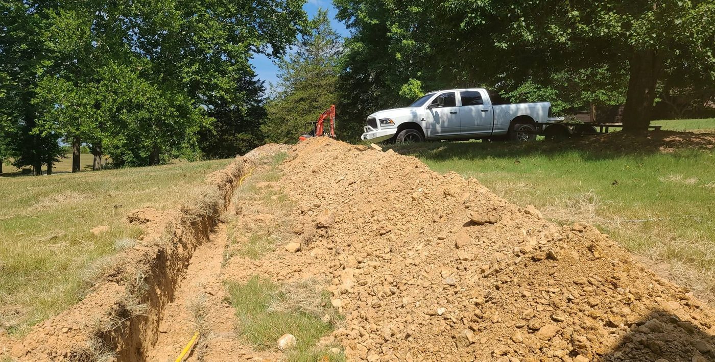 A long utility trench cut across a property by Dirty Deeds Excavation