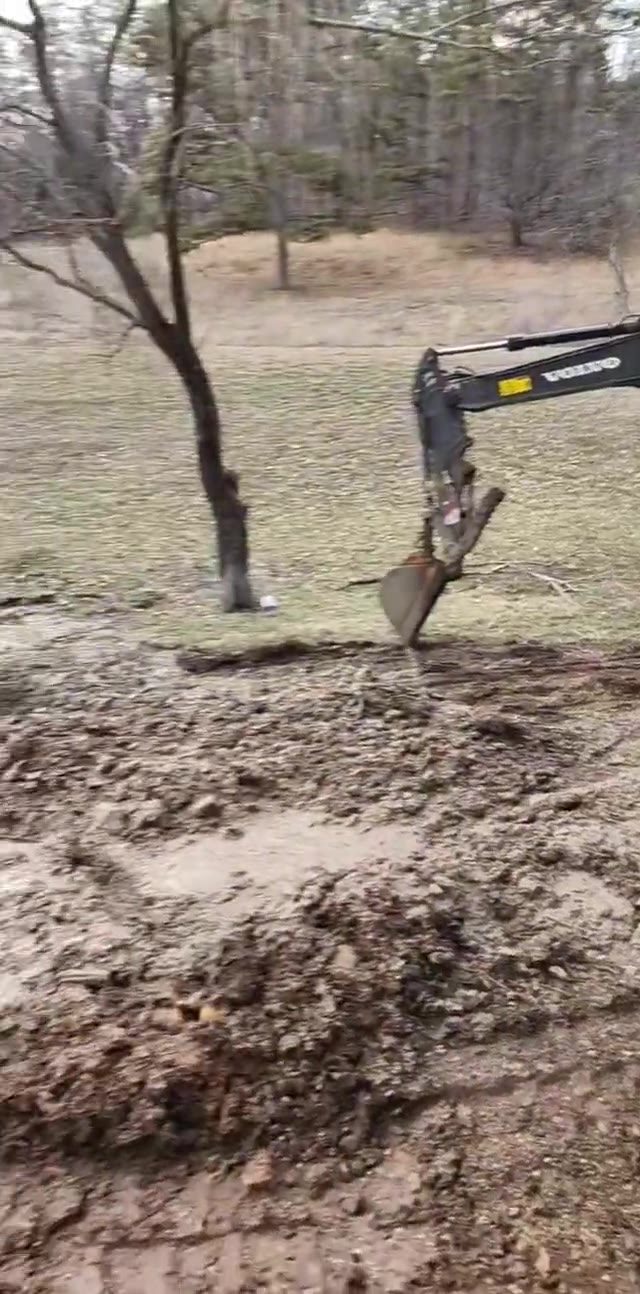An excavator working ground on site