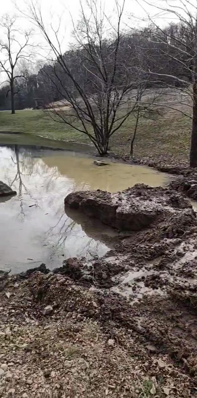 Dirt work alongside a pond on a Dirty Deeds job